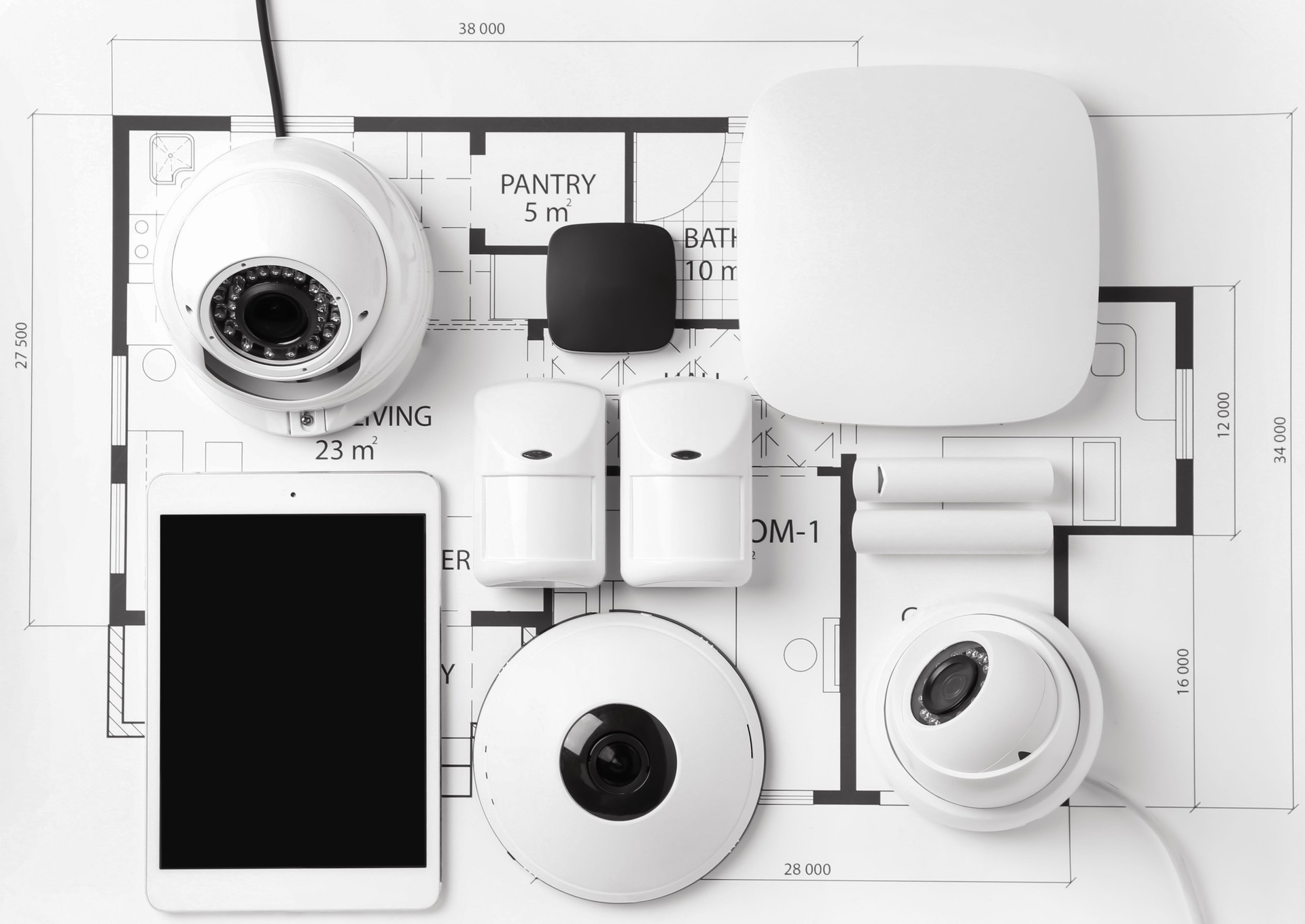 Various smart home security devices on a house floor plan blueprint